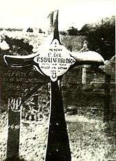 Crucifix, made from an aeroplane propeller, in a cemetery. The inscription reads "Lt. Col. R.S. Dallas DSO DSC ... Killed in Action"