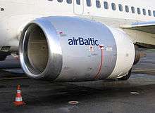 A close-up view of a CFM56-3 series engine mounted on a Boeing 737-300 showing flattening of the nacelle at the bottom of the inlet lip.