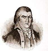 The man from the coin, Moses Cleaveland, in an engraving. He is seen more fully than on the coin, facing slightly right, and wears late 18th or early 19th century garb. He appears about 50 years old and has a sour expression on his face.