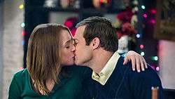 A photo of Alica Witt and George Stults kissing