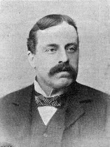 Photograph of a man in a suit