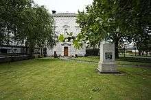 Façade of the museum with trees in the foreground.