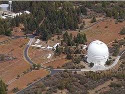 PTI is located atop Palomar Mountain, next to the large white dome of the historic 5&nbsp;m Hale Telescope.