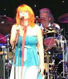 Brown singing into a microphone onstage