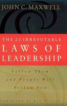 Three rectangles on top of each other, the top one black, the middle one red, and the bottom one gold, all with words on them, in gold, white, and black, respectively