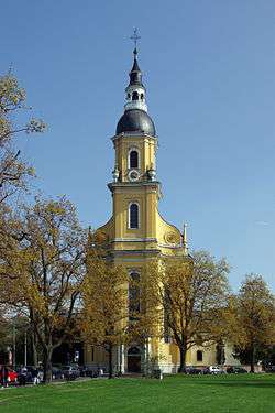 Almost straight-on view of the muted yellow, narrow, tall tower entrance of Saint Paulinus' Church