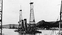 Photograph showing both ships partially underwater, the cage mast stick out of the water